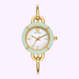 The Tory Burch Watches THE MILLER TBW6019SET Women’s watch features a gold wristband with oval links, a round face accented by a mint green bezel, and a white mother-of-pearl dial with gold hands. Both the Tory Burch logo and name are positioned beneath the 12 o’clock mark. This interchangeable watch set from Tory Burch Watches is shown against a pale background.