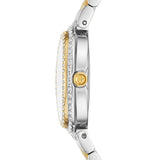 Side view of the Tory Burch Watches THE OVAL TBW6037 by Tory Burch Watches, featuring a round case in silver and gold tones with crystal accents around the bezel and a gold crown engraved with the brand’s logo. The two-tone stainless steel bracelet showcases both metallic silver and gold links, making this women’s luxury watch truly stunning.