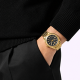A person wearing a Versace Watches VE6A00623 V-Code watch and dressed in black has their left hand in their pocket.