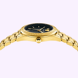 The Versace VE6A00623 V-Code Watch by Versace Watches features a gold-tone wristband and a black face accented with the iconic Greek key design on the bezel. Captured from a low side angle against a light purple background, this Swiss-made luxury timepiece perfectly showcases the bold, distinctive style of Versace.
