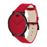 The Movado 0607429 Modern 47 by Movado Watches features a black case, bold red dial without numerals, minimalist black hands, and a red leather strap with white underside and black buckle for a sleek, modern look.