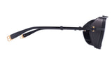Side view of Balmain O.R. BPS-104C-59 Unisex Sunglasses in black from Balmain Sunglasses, featuring a textured side shield and gold accents on the arm ends, shown against a white background.