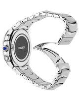 A silver Seiko Watches SSG019 Coutura Radio men’s watch with a metal link band is shown from the back, clasp open in a heart shape. The Lexor Miami model features a blue-accented side button.