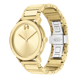 The Movado Watches 3600508 Bold Evolution is a men’s gold stainless steel watch with a minimalist, markerless dial, matching bracelet, and an engraved silver clasp interior. Swiss quartz movement. Displayed on a white background.