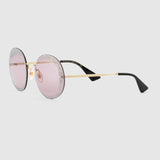 The Gucci GG0899S 001 61 Women Sunglasses feature round, crystal-embellished rims, light pink lenses, thin gold frames, and black arms—a stylish design inspired by Gucci Sunglasses.