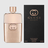 A bottle of Gucci Guilty Pour Femme 3.0 EDT Women Perfume by Gucci Perfumes is shown in a rose gold finish beside its stylish black and gold packaging, both displaying the iconic logo and product name—a must-have fragrance for women.