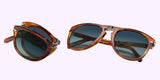 Two pairs of Persol PO0714SM 96/S3 54 Unisex Sunglasses by Persol Sunglasses in brown tortoiseshell with round blue-tinted lenses; one folded to show the folding design, the other open for a front and bridge view.