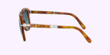 Side view of Persol PO0714SM 96/S3 54 Unisex Sunglasses by Persol Sunglasses, featuring tortoiseshell frames, dark lenses, silver arrow details on the arms, set against a light purple background.