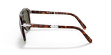 Side view of Persol PO0714SM 24/P1 54 Unisex Sunglasses by Persol Sunglasses, featuring tortoiseshell frames, green lenses, and signature silver arrow hinges—displayed on a white background. Inspired by classic Steve McQueen style.