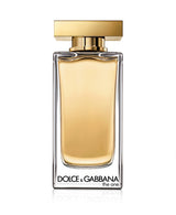 A clear glass bottle of Dolce&Gabbana Perfumes The One 3.3 oz EDT for women with gold liquid, a rectangular gold cap, and the brand name in black at the bottom, displayed against a white background.