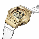 The G-Shock GM-6900SG-9 Gold Ingot Unisex Watch by G-Shock Watches features a clear resin strap, digital display, and gold-tone case and buttons, shown at an angle to highlight its striking design.