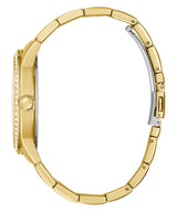 A side view of the Guess Watches GW0292L2 shows a gold stainless steel strap women’s watch with a round face and clear stones embedded around its elegant crystal case.