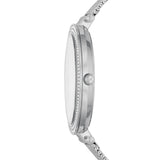 A side view of the Michael Kors MK4518 Darci Stainless Steel Strap Women Watch by Michael Kors Watches, featuring a slim profile, textured bezel, MK-etched crown, metal link band, and decorative stones at the lugs.