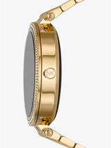 Side view of the Michael Kors MKT5127V Gen 5E Darci Pave Gold Stainless Steel Women's Smart Watch, featuring a round face with sparkling stones on the bezel, MK logo engraving, and a polished gold metal band and case.
