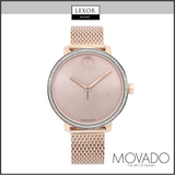 The Movado 3600657 women’s watch by Movado Watches features a rose gold mesh band, minimalist pink dial, and crystal-studded bezel, displayed on a white background with Lexor Miami and Movado logos.