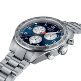 A close-up of the Tissot T1316171104200 PRS 516 Chronograph Men Watch Lexor Miami, featuring a blue dial, three subdials, tachymeter bezel, and silver metal link band from Tissot Watches on a white background.