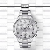 A Tissot T1166171103700 Chrono XL Classic Men’s Watch by Swatch Group with a stainless steel strap is shown on a LEXOR MIAMI patterned background, featuring three subdials, black numerals, and the Tissot logo.