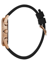 The Guess U1135L4 Solar Black Silicone Strap Women’s Watch by Guess Watches features a rose gold case, rhinestone bezel, two control buttons, and a black silicone strap with a matching rose gold buckle.