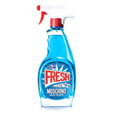 A blue bottle, shaped like a cleaning spray with a red and white nozzle, labeled Moschino Fresh Couture 3.4oz. EDT Women Perfume by Moschino Perfumes in bold red and white text on the front.