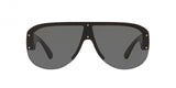 The Versace VE4391 GB1/87 48 Unisex Sunglasses feature oversized black shield-style frames, dark lenses, gold rivet accents at the corners and center, and a slightly curved top for a bold look.