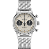 The Hamilton Watches H38429110 American Classic Intra-Matic Chronograph Men’s watch features a silver mesh band, cream dial, two black subdials, silver hour markers and hands, plus two pushers and a crown on the right.