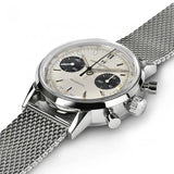 The Hamilton H38429110 American Classic Intra-Matic Chronograph by Hamilton Watches is a men's silver wristwatch with a mesh metal band, cream dial, two black subdials, and silver markers—shown close-up from the side to highlight crown and pushers.