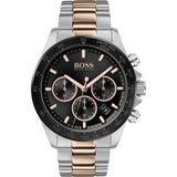 The Hugo Boss 1513757 Men's Watch features a stainless steel case, black dial with three subdials, date display, two-tone silver and rose gold strap, tachymeter-marked black bezel, and quartz analog movement.
