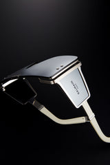 Metallic, futuristic Balmain BPS-102F-146 Wonder Boy LTD Unisex Sunglasses with cream straps and sleek design, capturing the style of Balmain Sunglasses—set against a dark background.