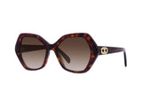 Celine CL40166I 5654F Women Sunglasses by Celine Sunglasses feature oversized tortoiseshell hexagonal frames, gradient brown lenses, and gold emblems on the temples—elegant Italian eyewear on a white background for a timeless look.